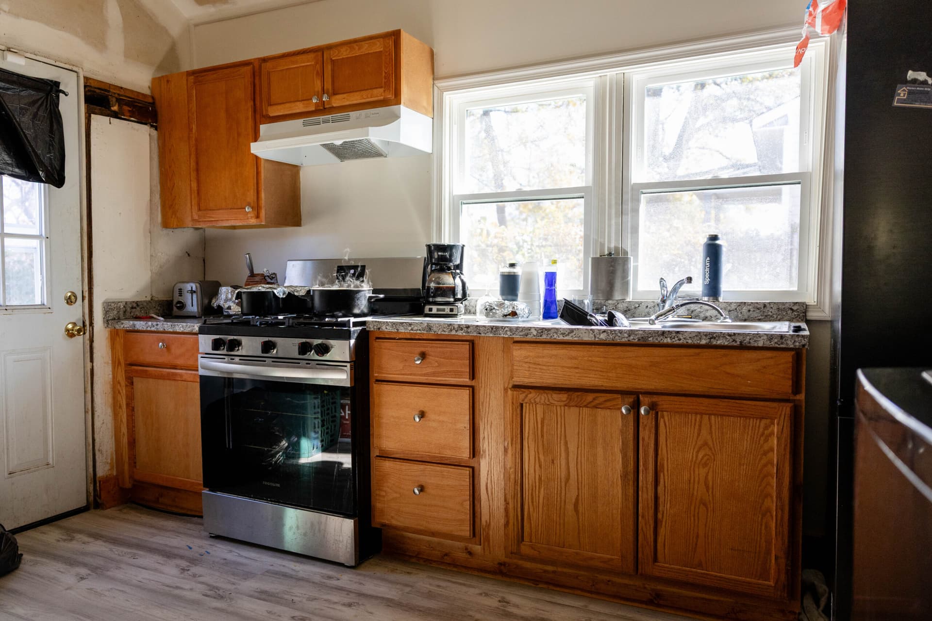 A kitchen with a pot on the stove.