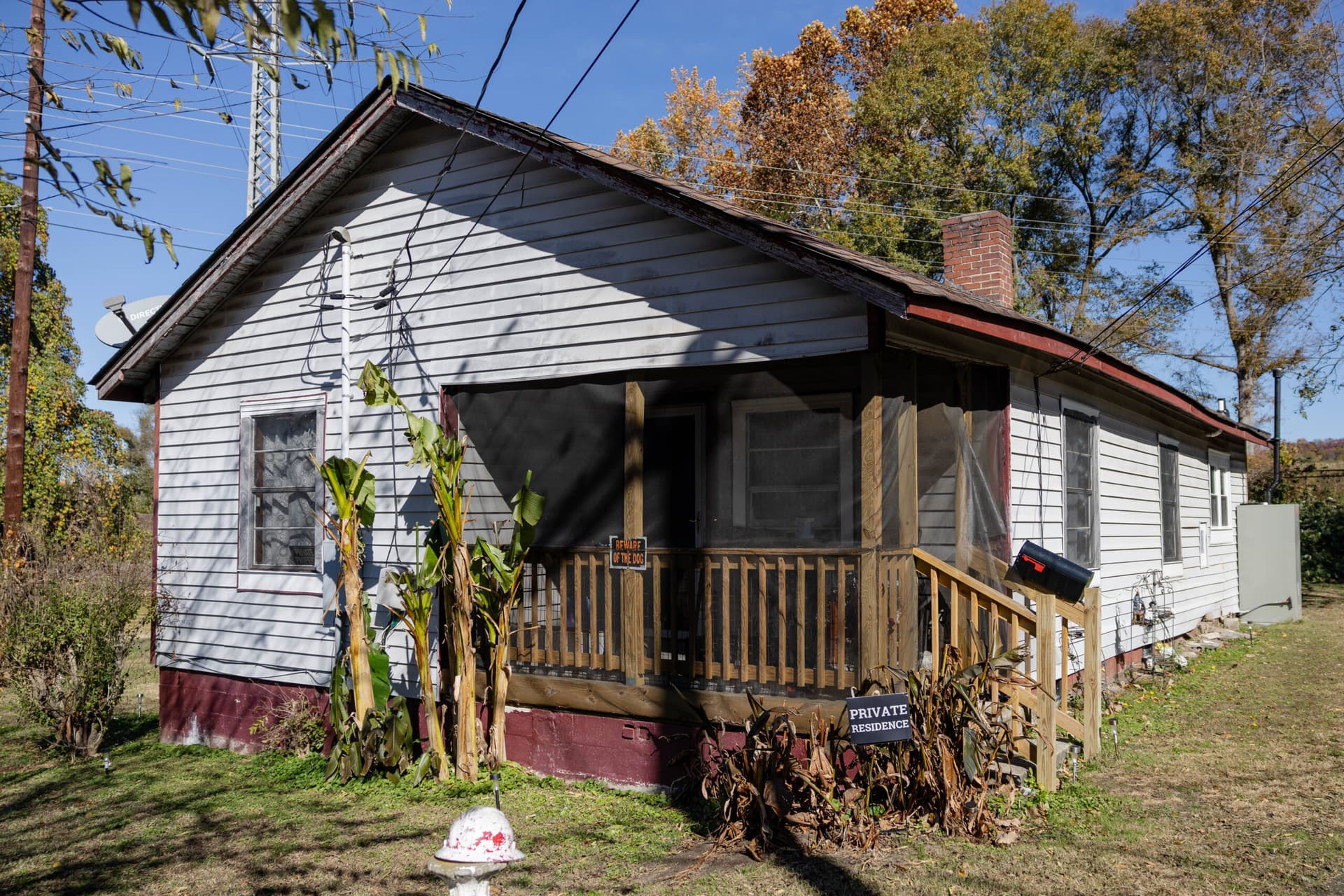 A house with a small front porch and plants.