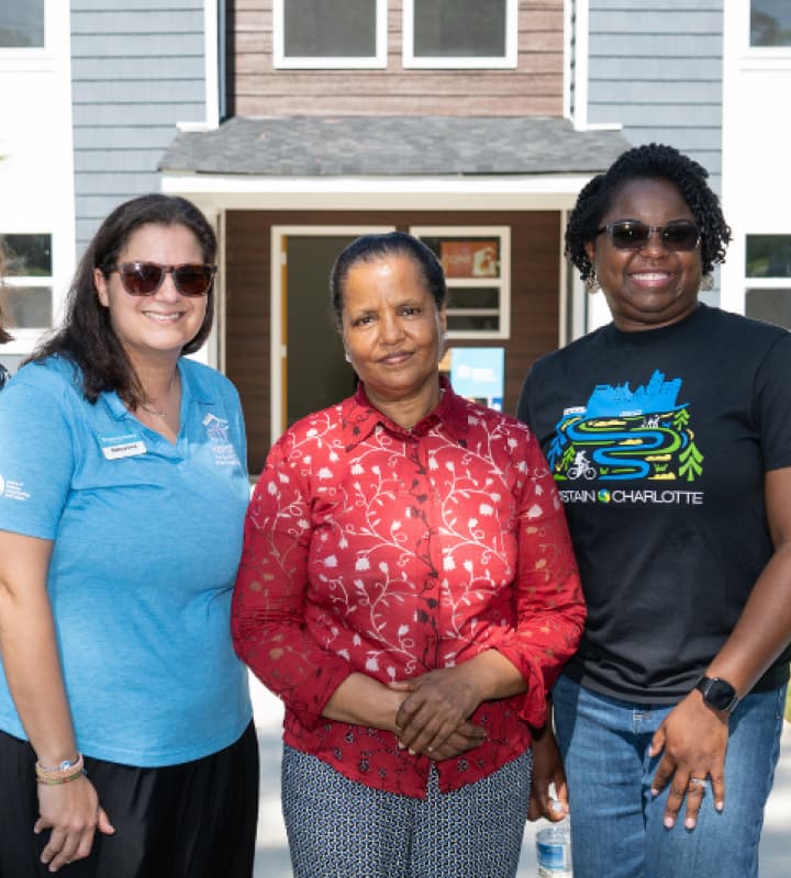 Women in front of a home
