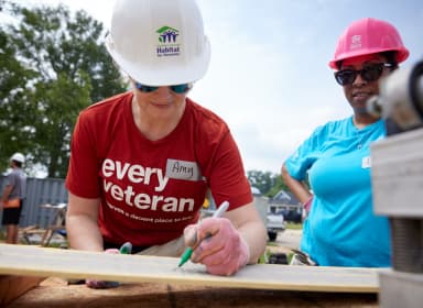 Veteran's Build marking a plank of wood