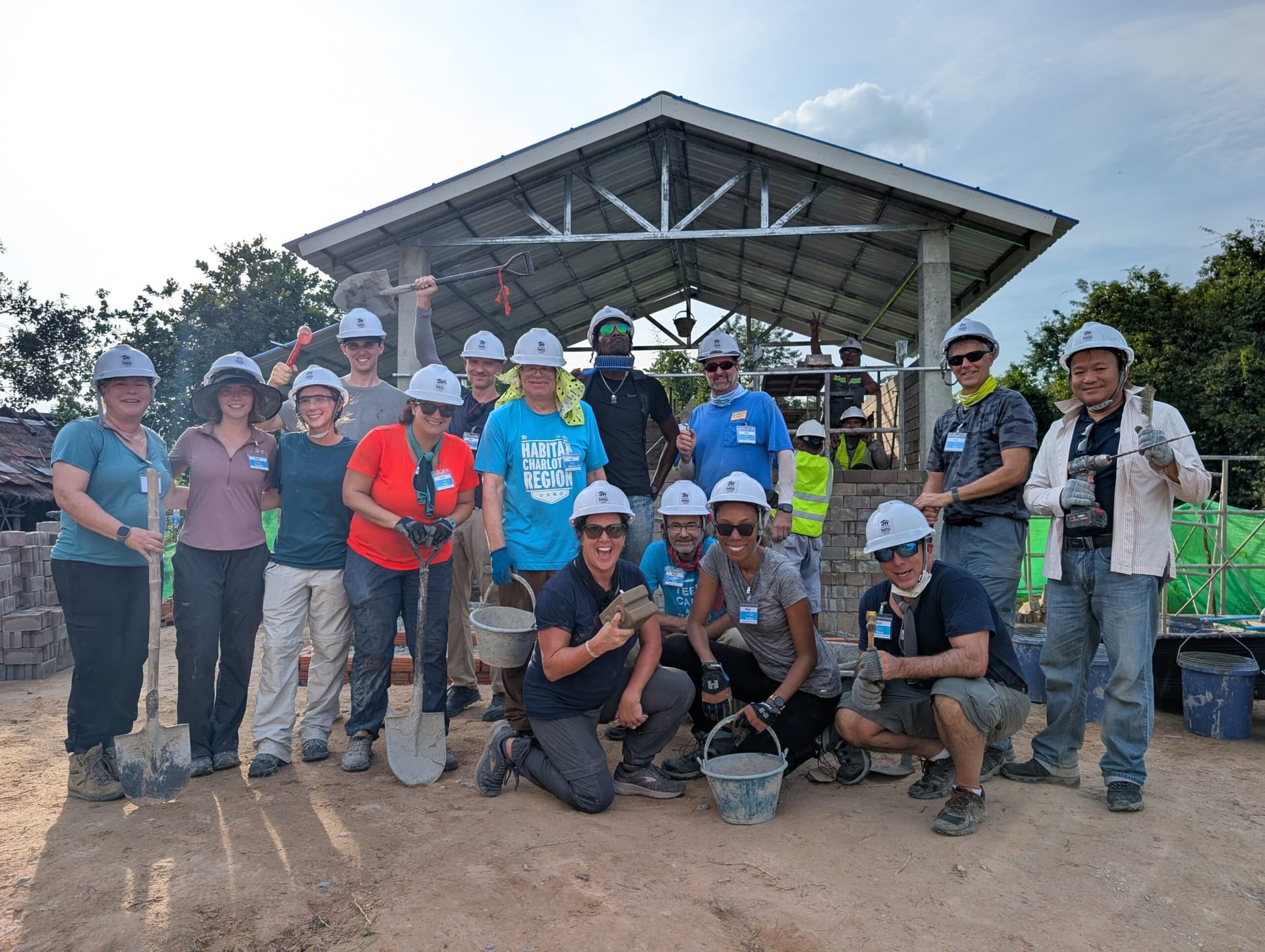 Volunteers posing in front of a completed home.