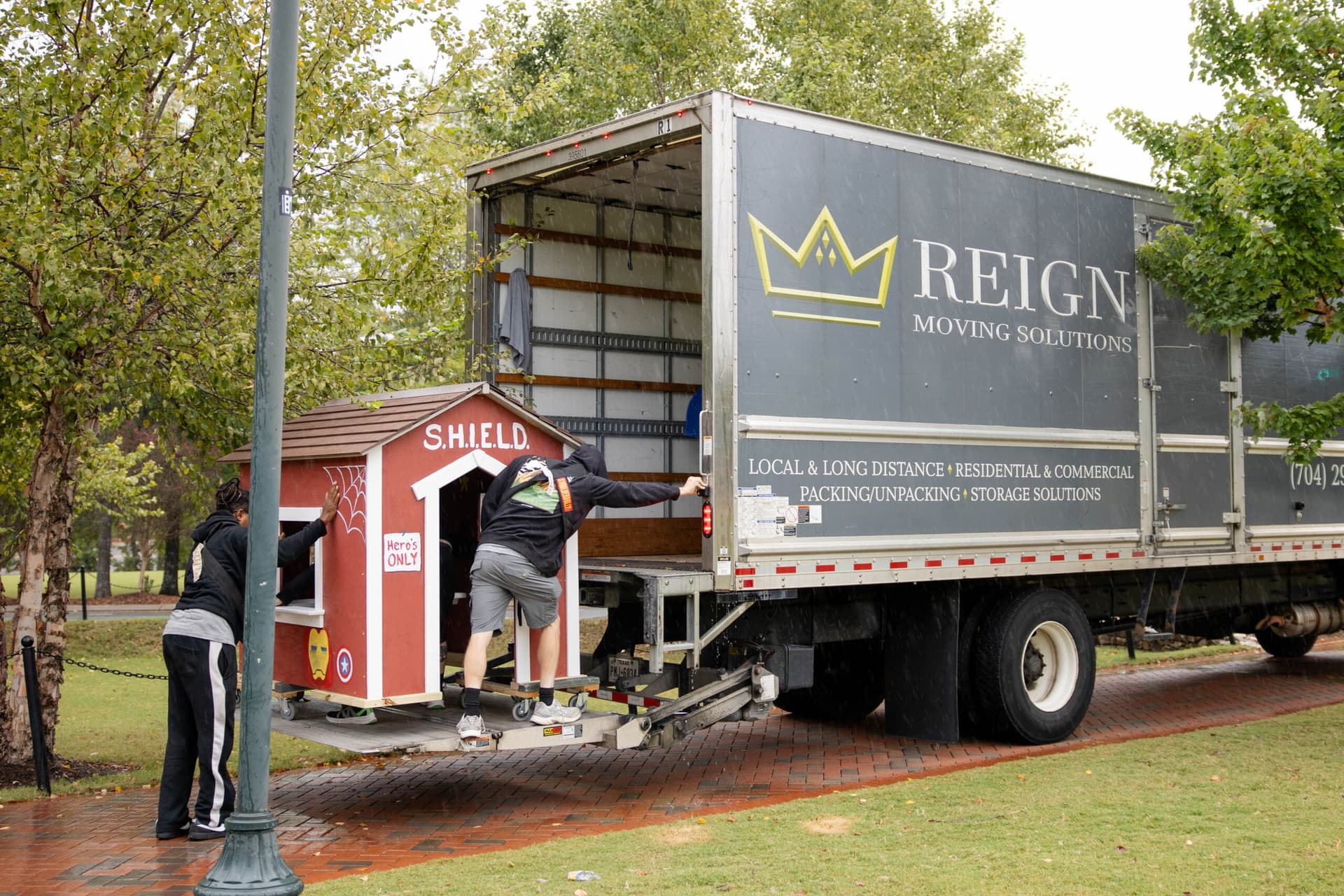 Reign Moving Solutions team moving and delivering playhouses
