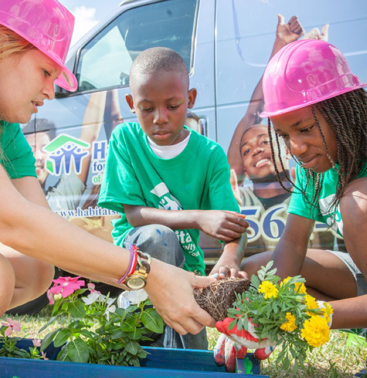 Students learning to plant a flower in Charlotte, NC
